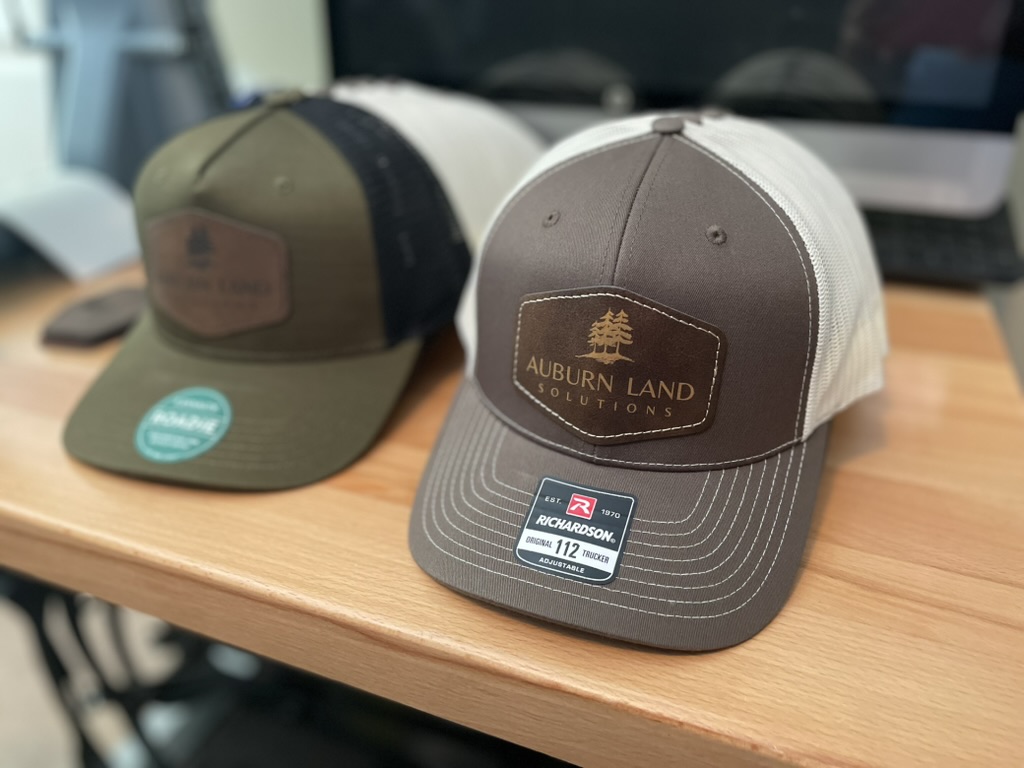 Two Richardson hats with custom engraved leatherette logo patches